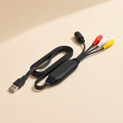 Signalgrab – Black flat-cable capture adapter coiled beside its yellow, white and red RCA plugs and S-Video connector