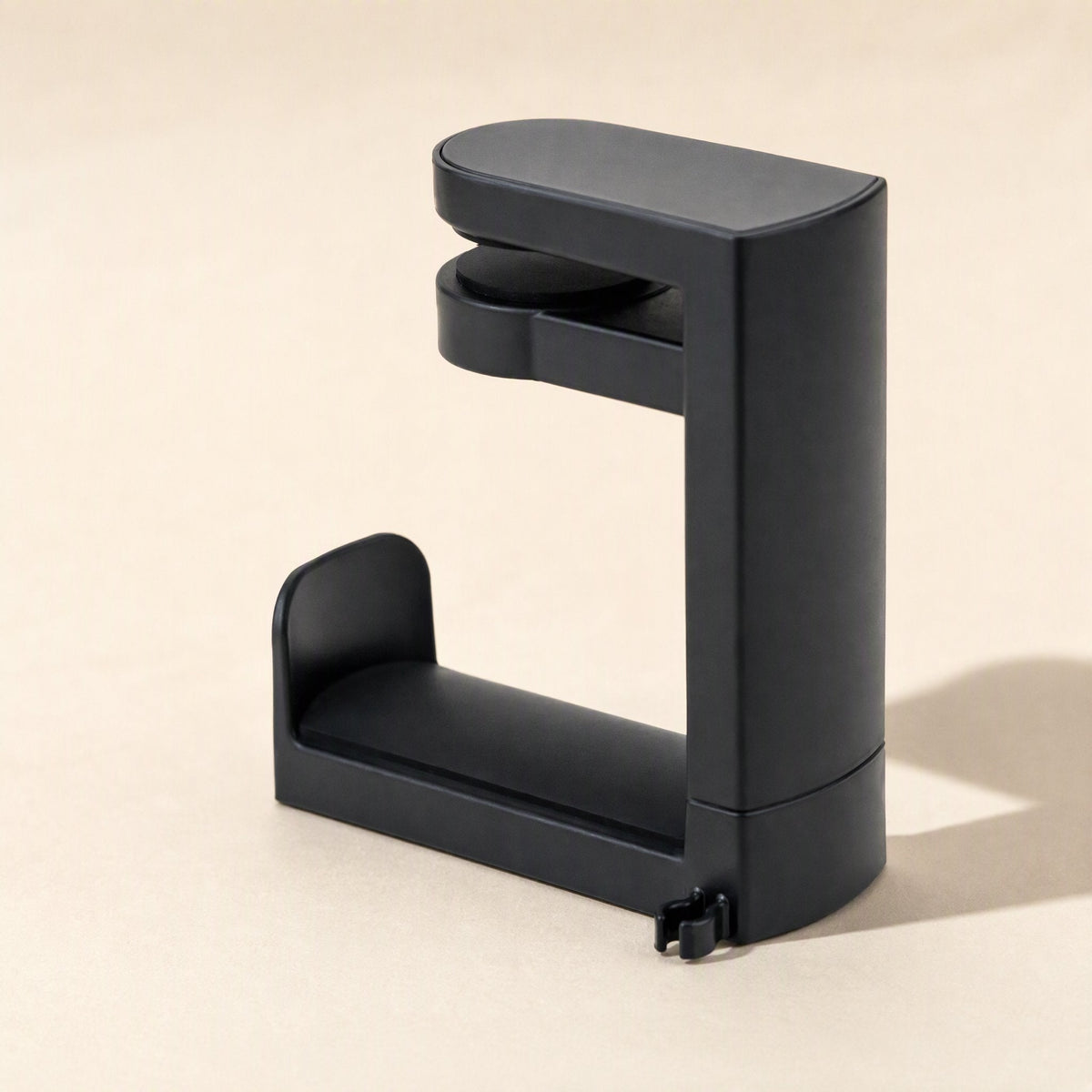Softperch – Rear three-quarter view of the black headphone holder showing its smooth back, clamp top and cradle