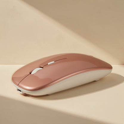 Roamclick – Rose gold wireless mouse with a cream underside and visible scroll wheel, resting on a sunlit tabletop
