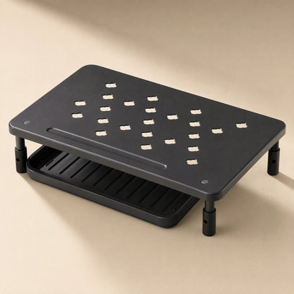 Risecrest – Black riser from above showing the perforated top, slot groove and open tray beneath on a beige background